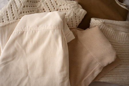 Stack of Neutral Knit Sweaters and Clothing Fabricsの写真素材