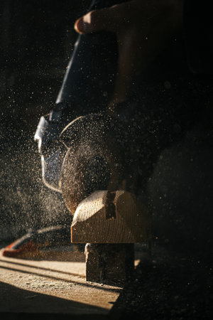 Close-up of woodworking process with flying sawdust and toolsの写真素材
