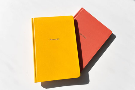 Yellow and Red Notebooks on White Background with Minimalist Aesthetic for Office and Study Themes