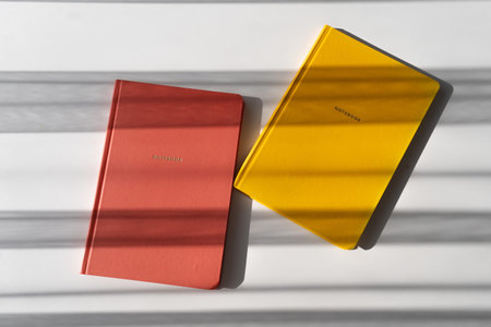 Yellow and Red Notebooks on White Background with Minimalist Aesthetic for Office and Study Themes