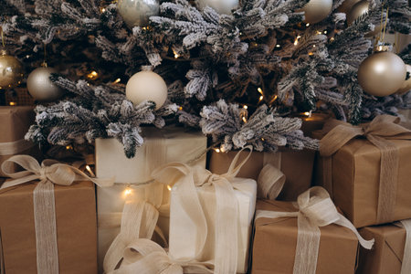 Close-Up of Wrapped Christmas Gifts Beneath Decorated Treeの写真素材