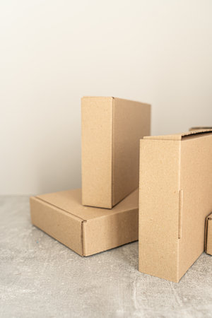 Close-up view of eco-friendly kraft cardboard boxes displayed on a neutral background. Perfect for sustainable packaging, gift wrapping, storage, and shipping needs.の写真素材