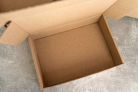 Open kraft cardboard box showing empty interiorの写真素材