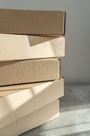 Stack of flat-packed self-assembly cardboard boxes for packaging and gift wrapping.