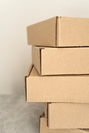 Close-up view of stacked kraft cardboard boxes for packaging and storageの写真素材