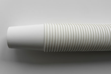 Stack of white paper cups on neutral background, minimalistic eco-friendly conceptの写真素材
