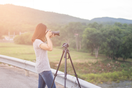 Travel take photo Public landmark, Young women take photo landscape, Woman holding dslr camera for shooting image in holiday,Travel take photo tourist camera photography conceptの写真素材
