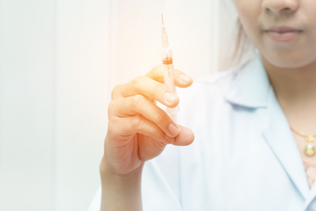 Close-up syringe in doctor hand,Woman doctor is about to inject the patient,Medical equipment,の写真素材