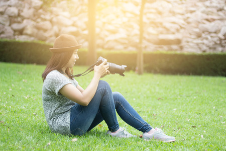 Women are learning photography,tourist taking photo on public place, Young woman holding Dslr cameraの写真素材