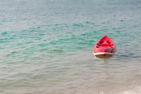 Small red boat on the beach.の写真素材