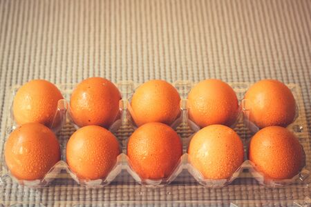 Cart and eggs with yellow background, Concept buying or selling eggsの写真素材