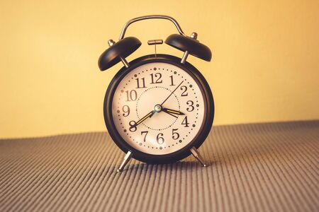 Alarm clock on the bed,  Wakes up in the morning, Vintage styleの写真素材