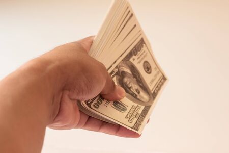 Young man prepare dollar to pay shoppingの写真素材