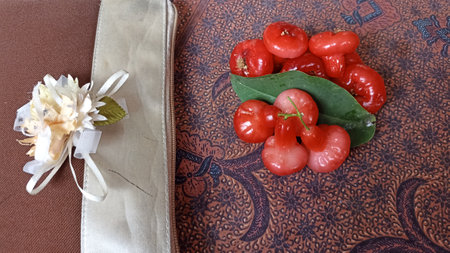 Water guava fruit with leaf on the batik tablecloth, top viewの写真素材