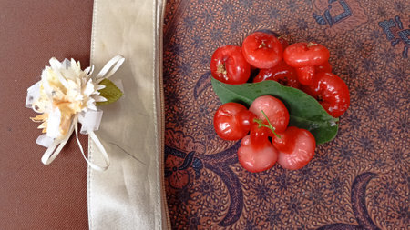 Water guava fruit with leaf on the batik tablecloth, top viewの写真素材