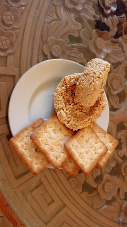 Crispy crackers on a white plate on a wooden tableの写真素材
