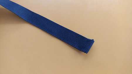 Blue belt on a beige background, close-up, copy spaceの写真素材