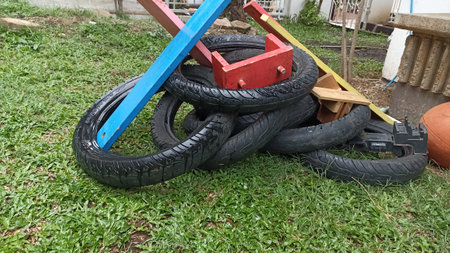 A pile of old motorcycle tires on the grass in the yard.の写真素材