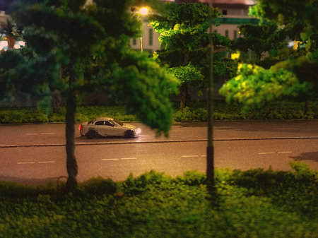 Miniature Car on the road at night in the city. Blurred backgroundの写真素材