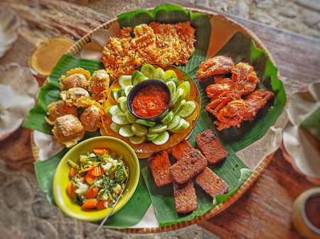 Traditional indonesian appetizer with pickles, cucumber, tomato sauce and chili sauceの写真素材