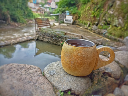 Cup of tea on a stone by the river in Bandung, Indonesia.の写真素材