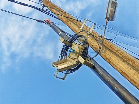 electricity post with wires on blue sky and white clouds background.の写真素材