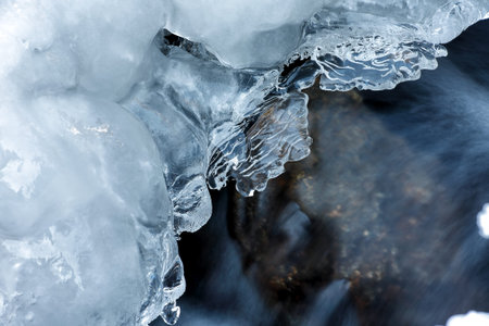 Mountain stream in winter. Ice on the stream.