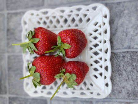 Heap of fresh strawberries in ceramic bowl.の写真素材