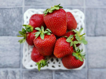 Heap of fresh strawberries in ceramic bowl.の写真素材