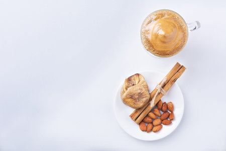 Dalgona Coffee Iced, a Korean fashionable whipped black instant coffee with milk, on a white...
