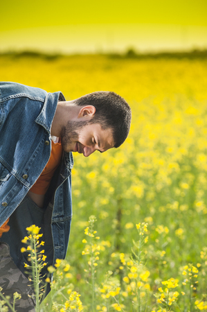 Farmer in rapesees fieldの写真素材