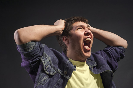 Close-up of a man screaming in agony.の写真素材