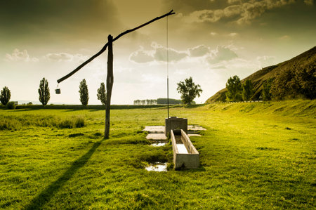 Shadoof on field at sunsetの写真素材