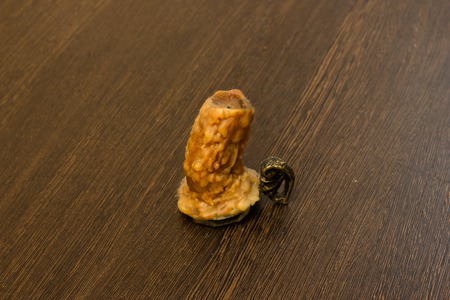 burning old candle vintage bronze candlestick  on a wooden surfaceの写真素材