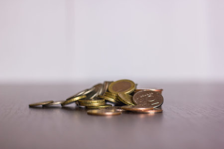 pile of russian coins on a wooden background with the euro in the middle