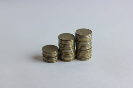 Side view of stacks of Russian coins increasing in height, on white studio backgroundの写真素材