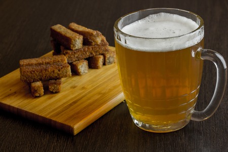 croutons of bread with beer with wooden placeの写真素材