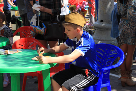 Voronezh, Russia - May 9, 2016: Celebration of 71th anniversary of the Victory Day (WWII). Boy saluting in Russian military field capのeditorial素材