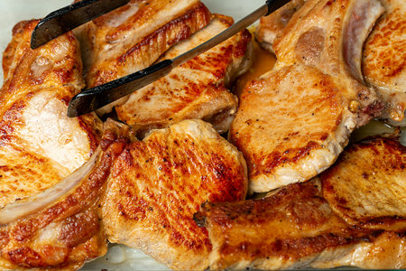Ready-made pork cutlets on a glass baking sheetの写真素材