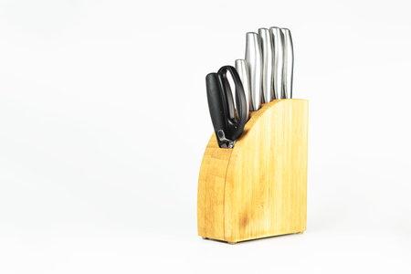 Set of kitchen knives with scissors on a white background.