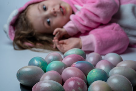 Little girl dressed as a bunny with Easter eggs