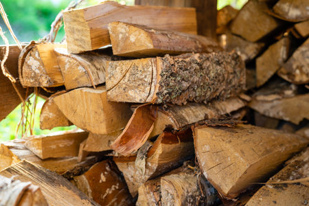 Woodpile of birch firewood. Procurement and storage of fuel for the winter