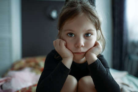 little girl in a gymnasium costume is waiting looking straight into the lensの写真素材