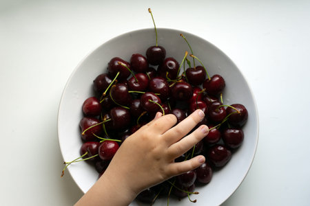 Healthy eating and food concept - cherries in white bowl.