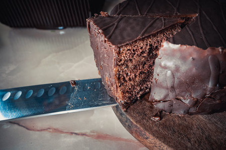 Round chocolate cake with triangular slice cut offの写真素材