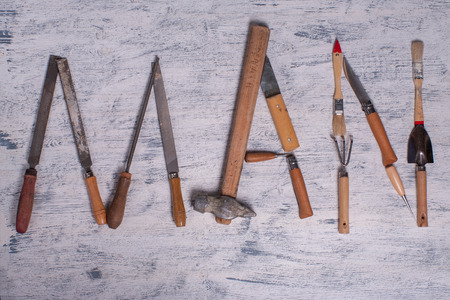 The inscription MAN is written by work tools. The word MAN is made up of a work tools.の写真素材