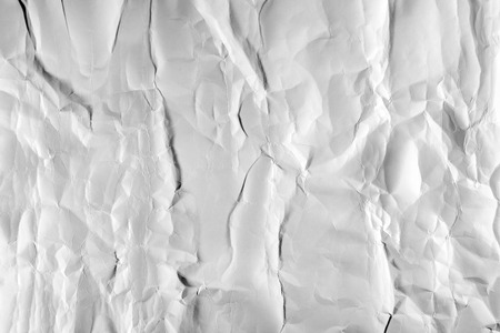 Texture of crumpled white paper with dents.の写真素材
