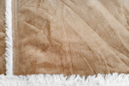 beige suede texture with artificial soft fur. closeup shammy background.