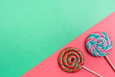 Set of colorful spiral lollipops on colored paper.の写真素材