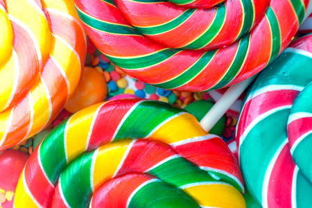 background from set of colorful spiral lollipops closeup.の写真素材